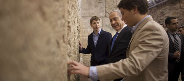 In this Jan. 22, 2013 file photo, Israeli Prime Minister Benjamin Netanyahu, center, prays with his sons Yair, background, and Avner, right, at the Western Wall, the holiest site where Jews can pray, in Jerusalem's Old City. Israeli political leaders are lashing out at Prime Minister Benjamin Netanyahu's eldest son for posting an anti-Semitic caricature aimed at his father's critics In this Jan. 22, 2013 file photo, Israeli Prime Minister Benjamin Netanyahu, center, prays with his sons Yair, background, and Avner, right, at the Western Wall, the holiest site where Jews can pray, in Jerusalem's Old City. Israeli political leaders are lashing out at Prime Minister Benjamin Netanyahu's eldest son for posting an anti-Semitic caricature aimed at his father's critics - Sputnik International