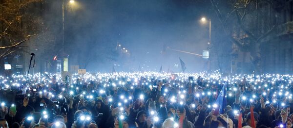 People take part in a protest against a proposed new labour law in Budapest, Hungary, December 16, 2018 - Sputnik International