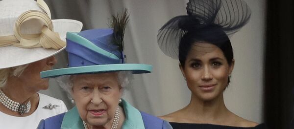 Britain's Queen Elizabeth II, Camilla the Duchess of Cornwall, left, and Meghan the Duchess of Sussex walk out onto the balcony to watch a flypast of Royal Air Force aircraft pass over Buckingham Palace in London, Tuesday, July 10, 2018. Britain's Queen Elizabeth II, Camilla the Duchess of Cornwall, left, and Meghan the Duchess of Sussex walk out onto the balcony to watch a flypast of Royal Air Force aircraft pass over Buckingham Palace in London, Tuesday, July 10, 2018. - Sputnik International
