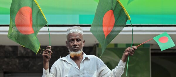 A Bangladeshi man waves national flags A Bangladeshi man waves national flags - Sputnik International