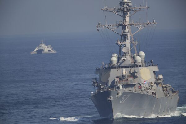 The USS Mitscher, part of a strike group led by the USS John C. Stennis aircraft carrier, sails as an Iranian Revolutionary Guard vessel shadows it on Friday, Dec. 21, 2018. The USS Mitscher, part of a strike group led by the USS John C. Stennis aircraft carrier, sails as an Iranian Revolutionary Guard vessel shadows it on Friday, Dec. 21, 2018. - Sputnik International