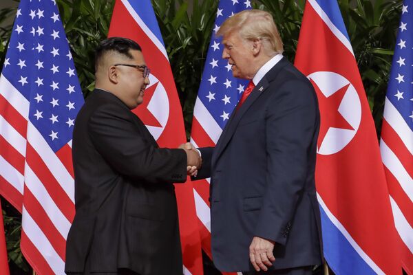 U.S. President Donald Trump shakes hands with North Korea leader Kim Jong Un at the Capella resort on Sentosa Island Tuesday, June 12, 2018 in Singapore. U.S. President Donald Trump shakes hands with North Korea leader Kim Jong Un at the Capella resort on Sentosa Island Tuesday, June 12, 2018 in Singapore. - Sputnik International
