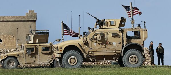 In this picture taken on Thursday, March 29, 2018, a fighter, second from right, of U.S-backed Syrian Manbij Military Council stands next to U.S. humvee at a U.S. troop's outpost on a road leading to the tense front line between Syrian Manbij Military Council fighters and Turkish-backed fighters, at Halawanji village, north of Manbij town, Syria - Sputnik International