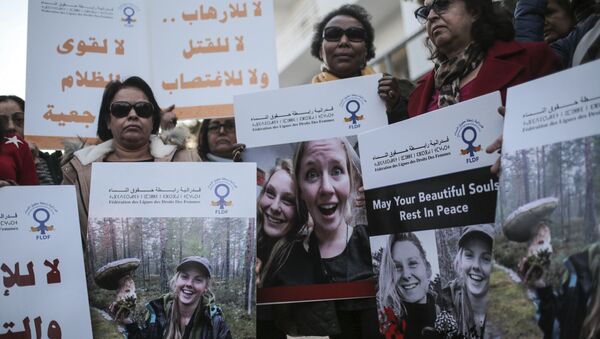 Moroccan women carry photos of 28-year-old Norwegian Maren Ueland and 24-year-old Danish Louisa Vesterager Jespersen, during a candlelight vigil outside the Danish embassy in Rabat for the two Scandinavian university students who were killed in a terrorist attack in a remote area of the Atlas Mountains, Morocco, Saturday, Dec. 22, 2018 - Sputnik International