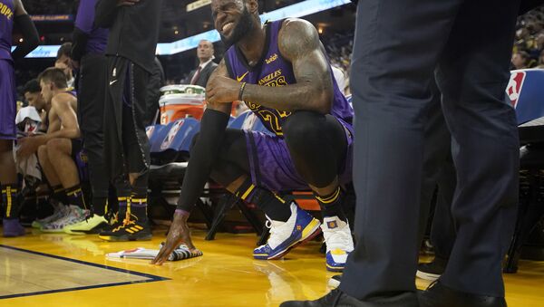 Los Angeles Lakers forward LeBron James (23) grimaces after straining his left groin, during the second half of the team's NBA basketball game against the Golden State Warriors on Tuesday, Dec. 25, 2018, in Oakland, Calif. - Sputnik International