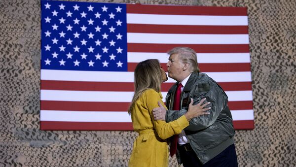 President Donald Trump kisses first lady Melania Trump during a hanger rally at Al Asad Air Base, Iraq, Wednesday, Dec. 26, 2018 - Sputnik International