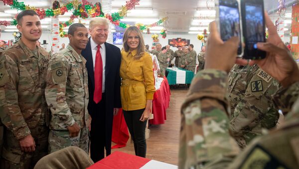 US President Donald Trump and First Lady Melania Trump take photos with members of the US military during an unannounced trip to Al Asad Air Base in Iraq on December 26, 2018 - Sputnik International
