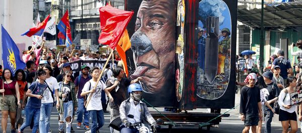 Protesters march with a rotating effigy of Philippine President Rodrigo Duterte for a rally near the Presidential Palace to mark the UN Declaration of International Human Rights Day Monday, Dec. 10, 2018 in Manila, Philippines. The protesters accuse the President of alleged rampant human rights violations since taking office more than two years ago Protesters march with a rotating effigy of Philippine President Rodrigo Duterte for a rally near the Presidential Palace to mark the UN Declaration of International Human Rights Day Monday, Dec. 10, 2018 in Manila, Philippines. The protesters accuse the President of alleged rampant human rights violations since taking office more than two years ago - Sputnik International