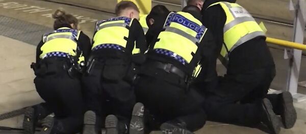 UGC issued by PA shows Police restraining a man after he stabbed three people at Victoria Station in Manchester, England, late Monday Dec. 31, 2018 - Sputnik International