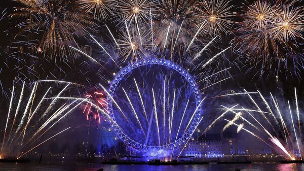 Fireworks explode over the London Eye during the New Year's eve celebrations after midnight in London, Tuesday, Jan. 1, 2019 - Sputnik International