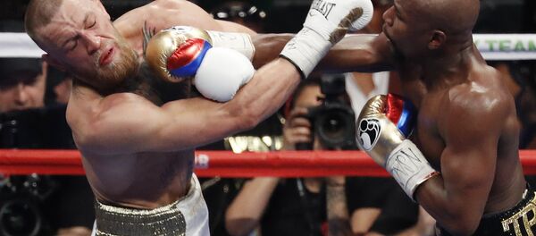 In this Aug. 26, 2017, file photo, Floyd Mayweather Jr., right, hits Conor McGregor during a super welterweight boxing match in Las Vegas In this Aug. 26, 2017, file photo, Floyd Mayweather Jr., right, hits Conor McGregor during a super welterweight boxing match in Las Vegas - Sputnik International