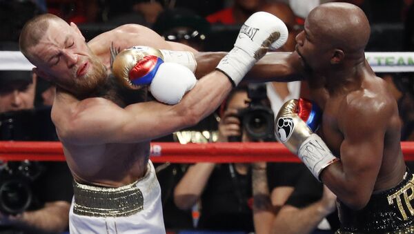 In this Aug. 26, 2017, file photo, Floyd Mayweather Jr., right, hits Conor McGregor during a super welterweight boxing match in Las Vegas - Sputnik International