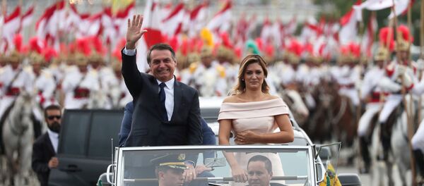 Brazil's new President Jair Bolsonaro waves as he drives past before his swear-in ceremony Brazil's new President Jair Bolsonaro waves as he drives past before his swear-in ceremony - Sputnik International