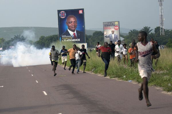 Supporters of opposition candidate Martin Fayulu run from tear gas fired by police in Nsele, Democratic Republic of the Congo, on December 19 Supporters of opposition candidate Martin Fayulu run from tear gas fired by police in Nsele, Democratic Republic of the Congo, on December 19 - Sputnik International