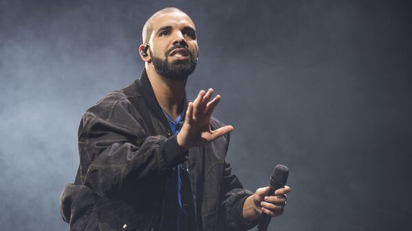 In this Oct. 8, 2016 file photo, Drake performs onstage in Toronto. Drake along with Rihanna and Kanye West scored eight Grammy nominations each, announced Tuesday, Dec. 6. - Sputnik International