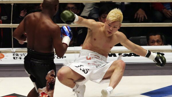 Japanese kickboxer Tenshin Nasukawa lies on the mat after being knocked out by Floyd Mayweather Jr. during first round of their three-round exhibition match on New Year's Eve, at Saitama Super Arena in Saitama, north of Tokyo, Monday, Dec. 31, 2018. - Sputnik International