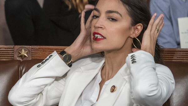 Rep. Alexandria Ocasio-Cortez, D-N.Y., holds a hair clip between her teeth as she pulls her hair back, on the opening day of the 116th Congress, at the Capitol in Washington, Thursday, Jan. 3, 2019 - Sputnik International
