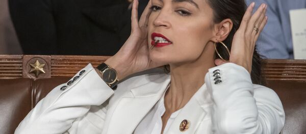 Rep. Alexandria Ocasio-Cortez, D-N.Y., holds a hair clip between her teeth as she pulls her hair back, on the opening day of the 116th Congress, at the Capitol in Washington, Thursday, Jan. 3, 2019 - Sputnik International