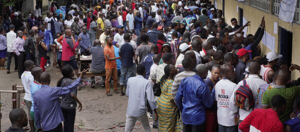 Hundreds of Congolese voters who have been waiting at the St. Raphael school in the Limete district of Kinshasa Sunday Dec. 30, 2018, storm the polling stations after the voters listings were finally posted five hours after the official start of voting. Forty million voters are registered for a presidential race plagued by years of delay and persistent rumors of lack of preparation. (AP Photo/Jerome Delay) Hundreds of Congolese voters who have been waiting at the St. Raphael school in the Limete district of Kinshasa Sunday Dec. 30, 2018, storm the polling stations after the voters listings were finally posted five hours after the official start of voting. Forty million voters are registered for a presidential race plagued by years of delay and persistent rumors of lack of preparation. (AP Photo/Jerome Delay) - Sputnik International