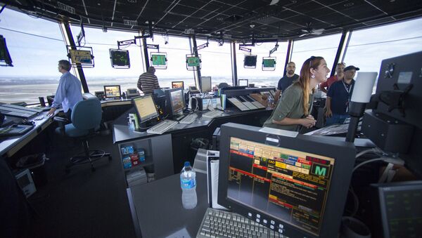 FAA Air Traffic Controllers work in the Dulles International Airport Air Traffic Control Tower in Sterling, Va - Sputnik International