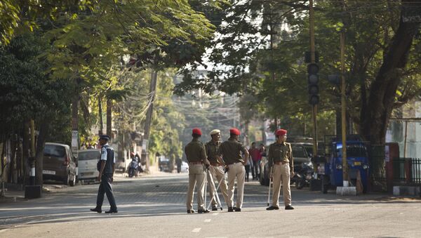Indian police officials stand leisurely on a deserted road during an eleven hour general strike called by All Assam Students' Union (AASU) and North East Students' Organization (NESO) in Gauhati, India, Tuesday, Jan. 8, 2019. - Sputnik International
