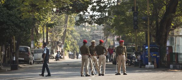 Indian police officials stand leisurely on a deserted road during an eleven hour general strike called by All Assam Students' Union (AASU) and North East Students' Organization (NESO) in Gauhati, India, Tuesday, Jan. 8, 2019. - Sputnik International