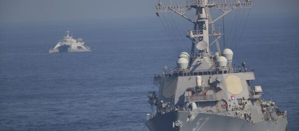 The USS Mitscher, part of a strike group led by the USS John C. Stennis aircraft carrier, sails as an Iranian Revolutionary Guard vessel shadows it on Friday, Dec. 21, 2018 The USS Mitscher, part of a strike group led by the USS John C. Stennis aircraft carrier, sails as an Iranian Revolutionary Guard vessel shadows it on Friday, Dec. 21, 2018 - Sputnik International