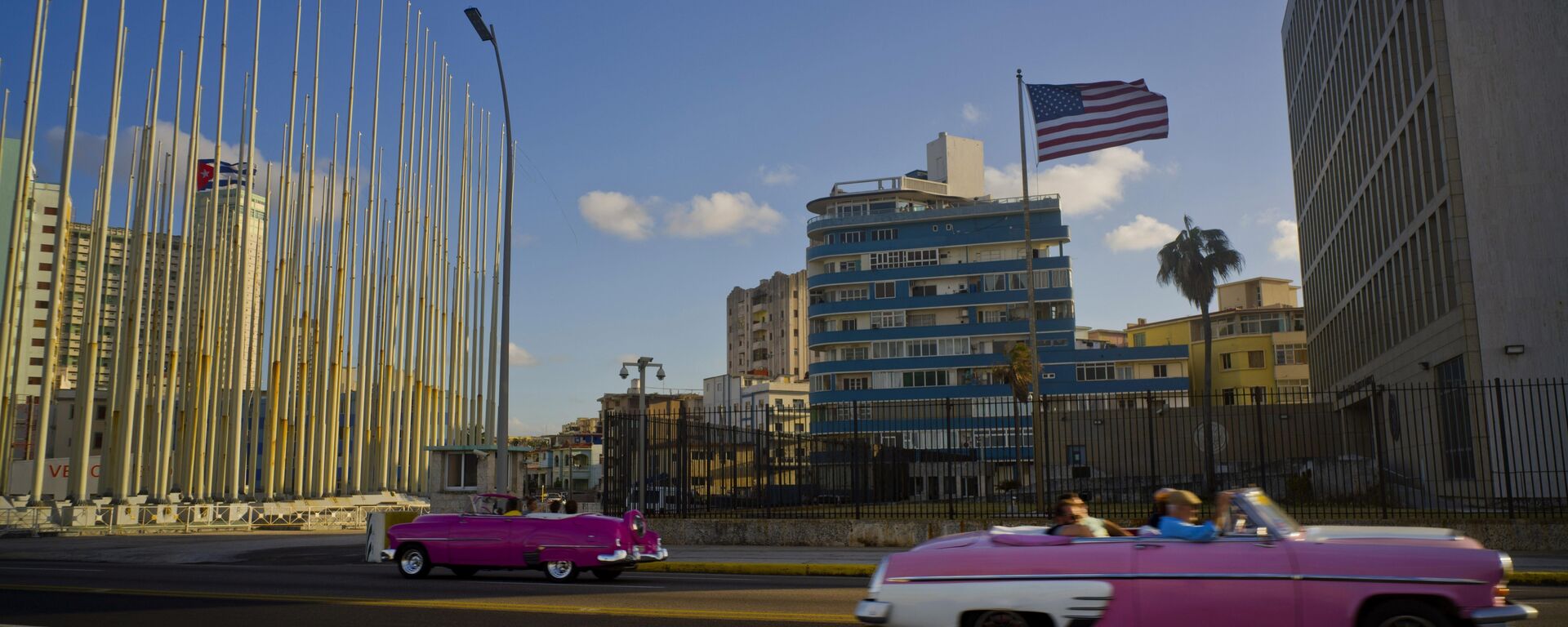 Jan. 12, 2017 file photo, tourists ride in classic American convertible cars past the United States embassy, right, in Havana, Cuba - Sputnik International, 1920