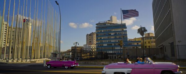 Jan. 12, 2017 file photo, tourists ride in classic American convertible cars past the United States embassy, right, in Havana, Cuba Jan. 12, 2017 file photo, tourists ride in classic American convertible cars past the United States embassy, right, in Havana, Cuba - Sputnik International