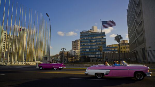 Jan. 12, 2017 file photo, tourists ride in classic American convertible cars past the United States embassy, right, in Havana, Cuba - Sputnik International
