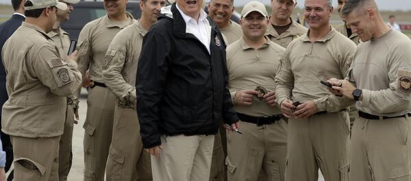 President Donald Trump turns as he talks to U.S. Customs and Border Protection officers at McAllen International Airport as he prepares to leave after a visit to the southern border, Thursday, Jan. 10, 2019, in McAllen, Texas - Sputnik International