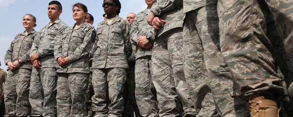 In this Tuesday, Dec. 10, 2013 photo, U.S. troops listen to Secretary of Defense Chuck Hagel, as he speaks at the Al Udeid air base in Qatar. In this Tuesday, Dec. 10, 2013 photo, U.S. troops listen to Secretary of Defense Chuck Hagel, as he speaks at the Al Udeid air base in Qatar. - Sputnik International
