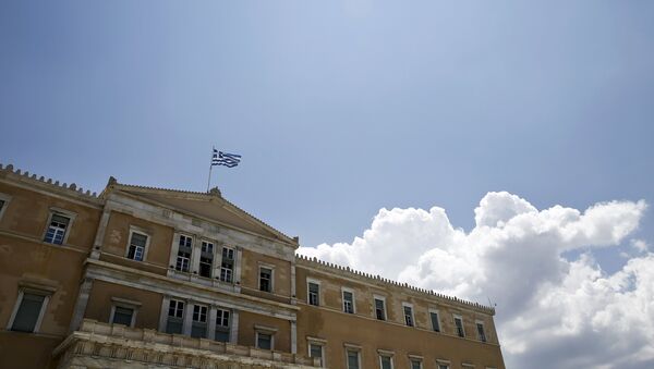 A Greek national flag flutters atop the parliament building in Athens, Greece June 29, 2015. - Sputnik International