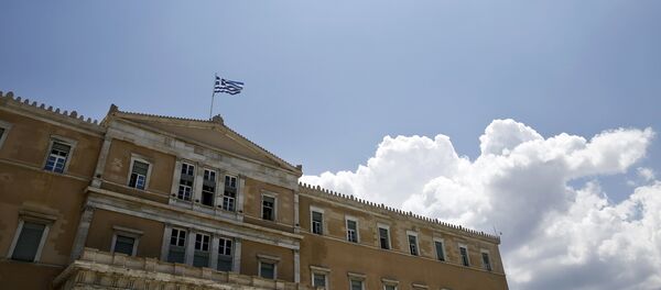 A Greek national flag flutters atop the parliament building in Athens, Greece June 29, 2015. A Greek national flag flutters atop the parliament building in Athens, Greece June 29, 2015. - Sputnik International