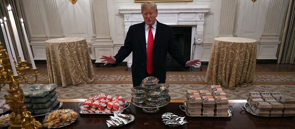 President Donald Trump talks to the media about the table full of fast food in the State Dining Room of the White House in Washington, Monday, Jan. 14, 2019, for the reception for the Clemson Tigers. President Donald Trump talks to the media about the table full of fast food in the State Dining Room of the White House in Washington, Monday, Jan. 14, 2019, for the reception for the Clemson Tigers. - Sputnik International