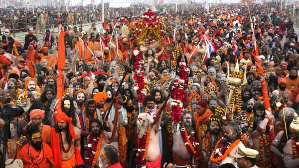 Hindu holy men arrive for ritualistic dip on auspicious Makar Sankranti day during the Kumbh Mela, or pitcher festival in Prayagraj, Uttar Pradesh state, India, Tuesday, Jan.15, 2019. - Sputnik International