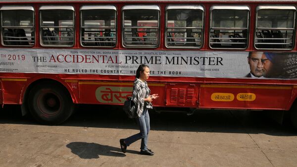 A woman walks past a bus featuring an advertising of the upcoming Bollywood film The Accidental Prime Minister in Mumbai, India, January, 5, 2019 - Sputnik International