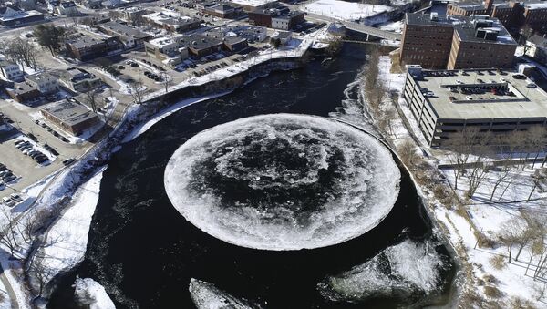 In this Monday, Jan. 14, 2019 aerial image taken from a drone video and provided by the City of Westbrook, Maine, a naturally occurring ice disk forms on the Presumpscot River in Westbrook, Maine. - Sputnik International