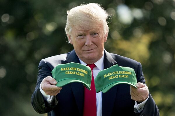 Donald Trump holding caps embossed with the logo Make Our Farmers Great Again in January 2019 Donald Trump holding caps embossed with the logo Make Our Farmers Great Again in January 2019 - Sputnik International