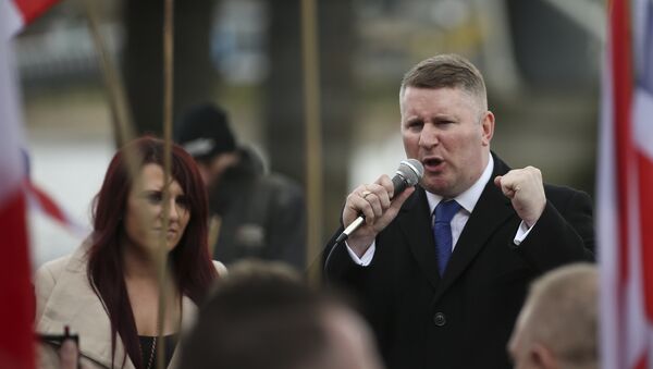 Paul Golding (R) and Jayda Fransen (L), leaders of the far-right organisation Britain First talk during a march in central London on April 1, 2017 - Sputnik International