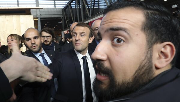 In this picture dated Feb. 24, 2017 French president Emmanuel Macron, center, visits the 55th International Agriculture Fair at the Porte de Versailles exhibition center in Paris, France, as Elysee senior security officer Alexandre Benalla, right, looks on - Sputnik International