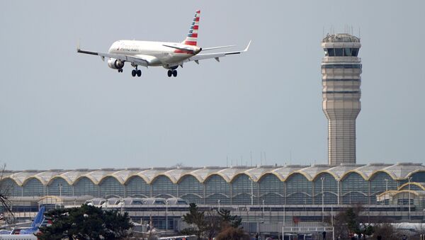 An airplane flies past the tower where air traffic controllers work despite not receiving their paychecks, on the 22nd day of a partial government shutdown at Reagan National Airport in Washington, U.S., January 12, 2019 - Sputnik International