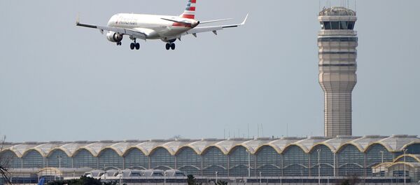 An airplane flies past the tower where air traffic controllers work despite not receiving their paychecks, on the 22nd day of a partial government shutdown at Reagan National Airport in Washington, U.S., January 12, 2019 - Sputnik International