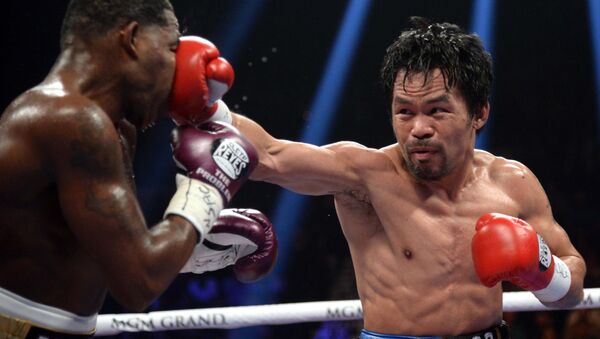 Jan 19, 2019; Las Vegas, NV, USA; Manny Pacquiao (black trunks) and Adrien Broner (purple/gold trunks) box during a WBA welterweight world title boxing match at MGM Grand Garden Arena. Pacquiao won via unanimous decision - Sputnik International