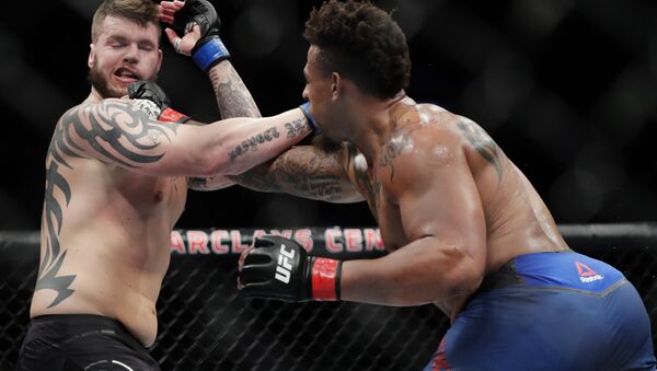 Greg Hardy, right, punches Allen Crowder during the second round of a heavyweight mixed martial arts bout at UFC Fight Night on Saturday, Jan. 19, 2019, in New York - Sputnik International