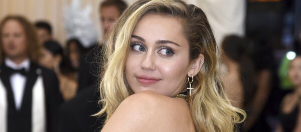 Miley Cyrus attends The Metropolitan Museum of Art's Costume Institute benefit gala celebrating the opening of the Heavenly Bodies: Fashion and the Catholic Imagination exhibition on Monday, May 7, 2018, in New York - Sputnik International
