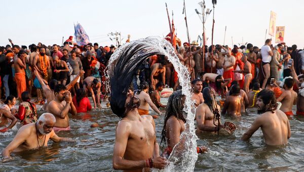 Naga Sadhus or Hindu holy men take a dip during the first Shahi Snan (grand bath) at Kumbh Mela or the Pitcher Festival, in Prayagraj, previously known as Allahabad, India, January 15, 2019 - Sputnik International