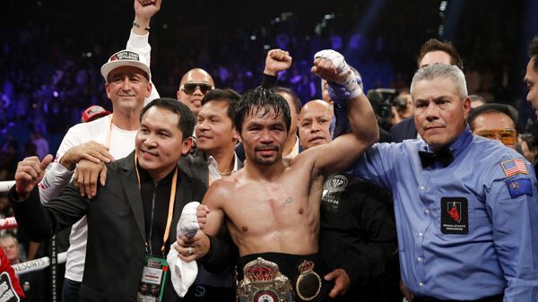 Manny Pacquiao's hand is raised after he retained the WBA world welterweight title on 19 January 2019 - Sputnik International