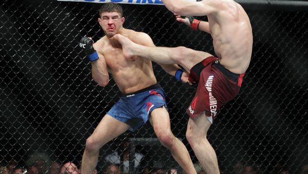 Russia's Khabib Nurmagomedov kicks Al Iaquinta during the fourth round of title bout at UFC 223 - Sputnik International