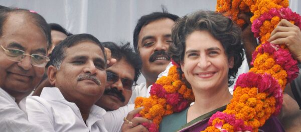 Priyanka Vadra, daughter of Congress party president Sonia Gandhi, receives a floral garland from supporters during an election campaign in her mother’s constituency of Rae Bareli, India, Wednesday, April 23, 2014. Priyanka Vadra, daughter of Congress party president Sonia Gandhi, receives a floral garland from supporters during an election campaign in her mother’s constituency of Rae Bareli, India, Wednesday, April 23, 2014. - Sputnik International
